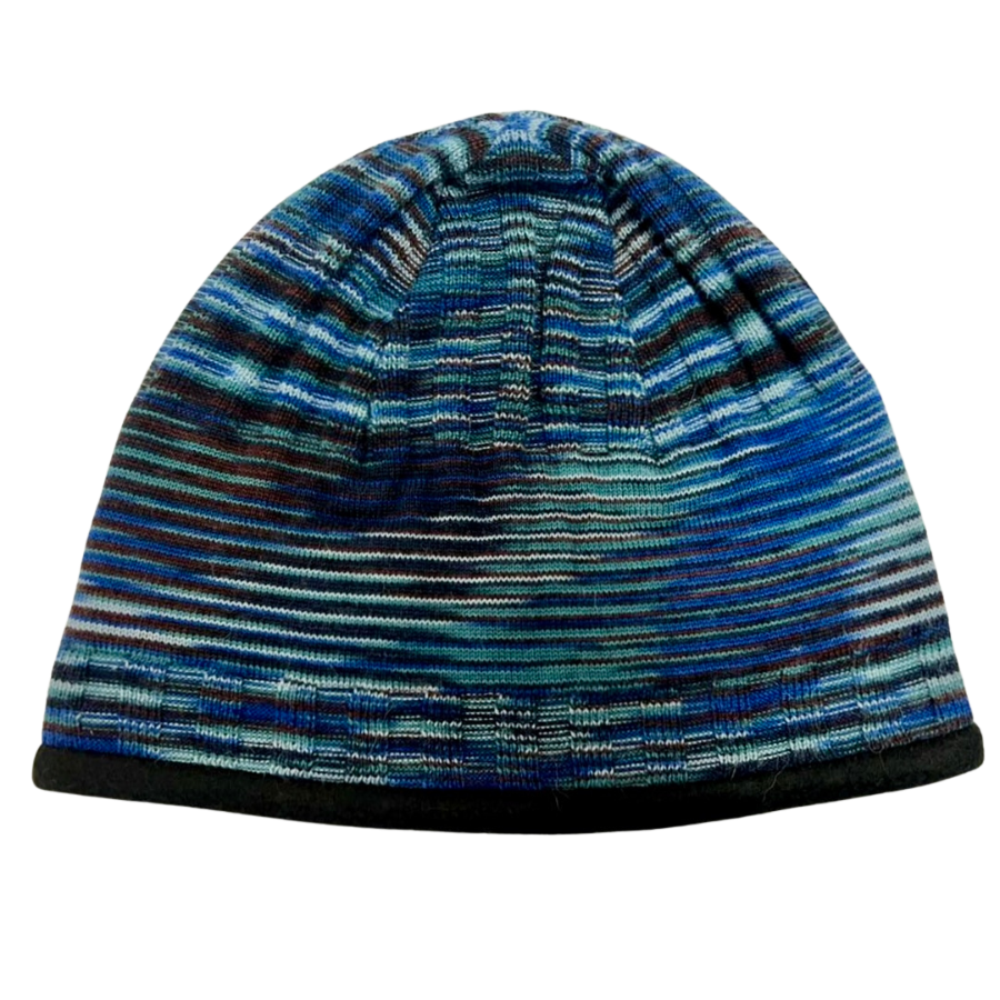 A product photo of the Alpacas of Montana soft cozy comfortable warm winter outerwear hiking skiing moisture wicking teal, blue, purple, gray, and black Multi-Blue Backcountry Beanie.