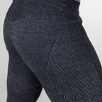 A close up photo of a pair of legs against a white background of a pair of the Alpacas of Montana warm underlayer cozy comfortable thermal moisture wicking long johns winter outerwear heavyweight antimicrobial alpaca wool men's red and black base layer bottoms for skiing, snowboarding, ice fishing, hunting, camping, arctic, travel