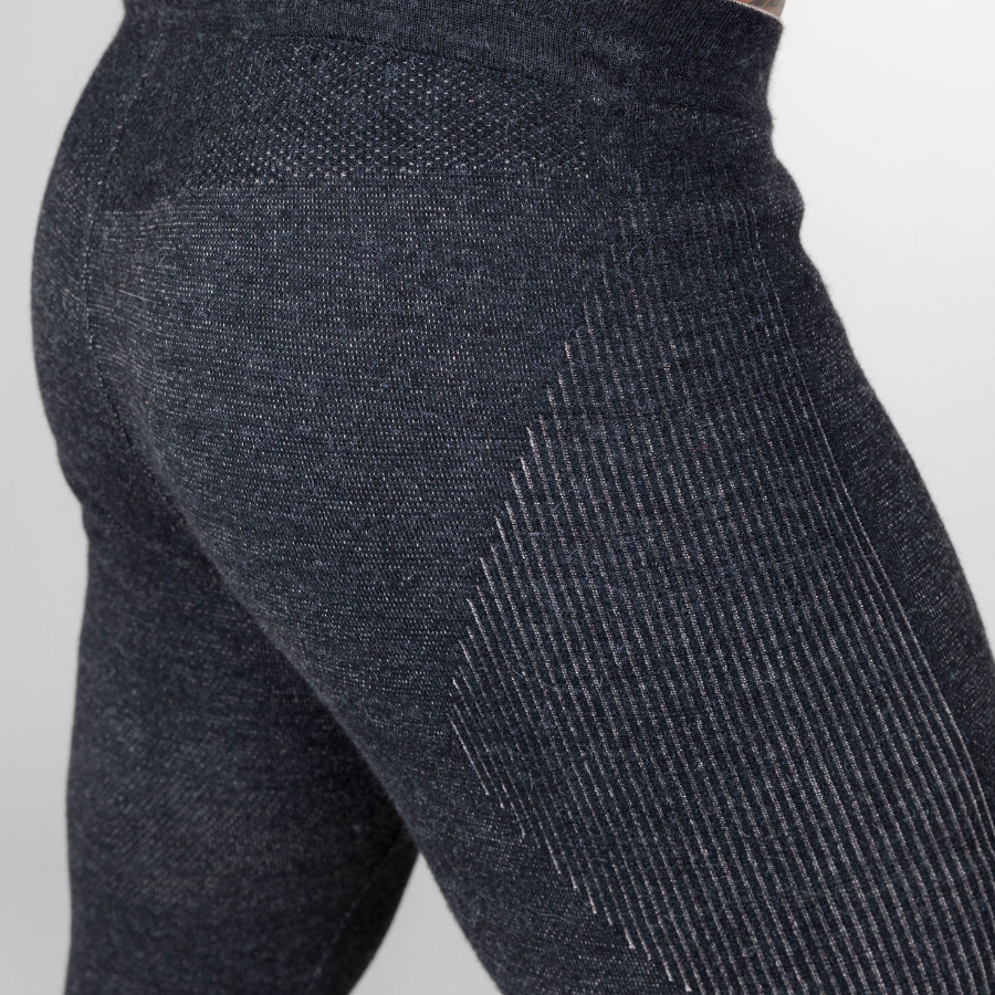 A close up photo of a pair of legs against a white background of a pair of the Alpacas of Montana warm underlayer cozy comfortable thermal moisture wicking long johns winter outerwear heavyweight antimicrobial alpaca wool men's red and black base layer bottoms for skiing, snowboarding, ice fishing, hunting, camping, arctic, travel
