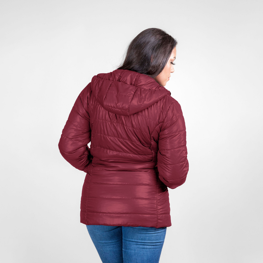 Woman wearing maroon alpaca winter parka with blue jeans