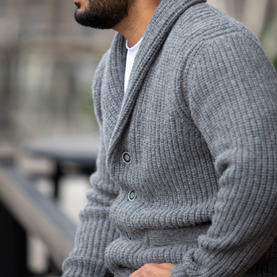 A close up torso photo of a man wearing an Alpacas of Montana cozy comfortable soft moisture wicking formal casual stylish upcycled men's medium gray button up chunky knit ribbed cardigan.