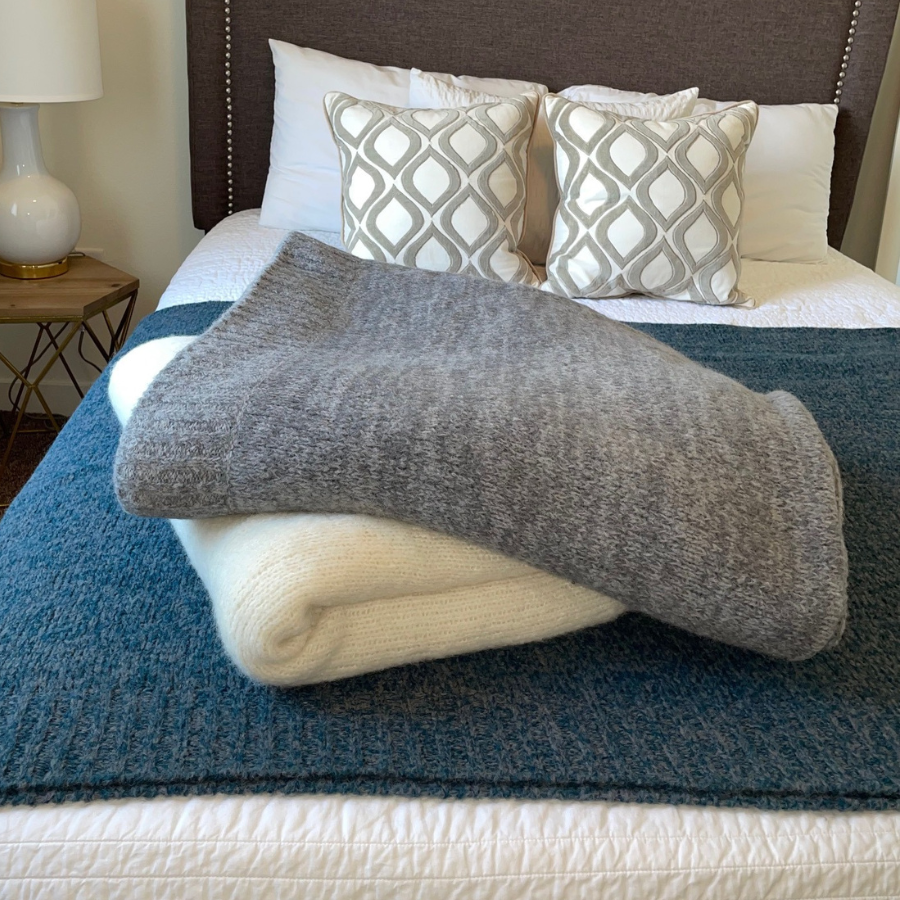 gray alpaca blanket on a white and blue alpaca blanket on a queen size bed
