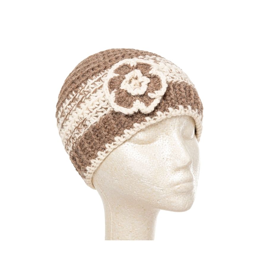 brown and white hand knit alpaca beanie hat with flower on mannequin head