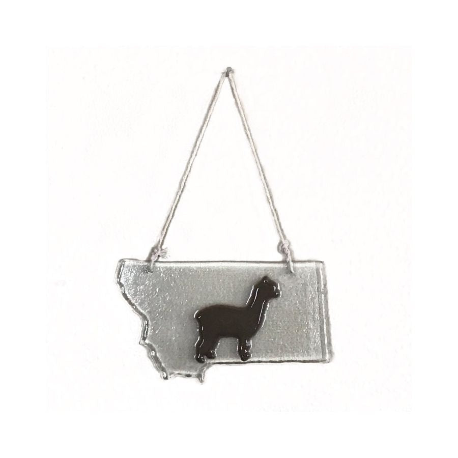 clear glass ornament in the shape of montana with a brown alpaca in the middle