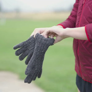 A video of a person pulling on a pair of Alpacas of Montana reversible knit mittens