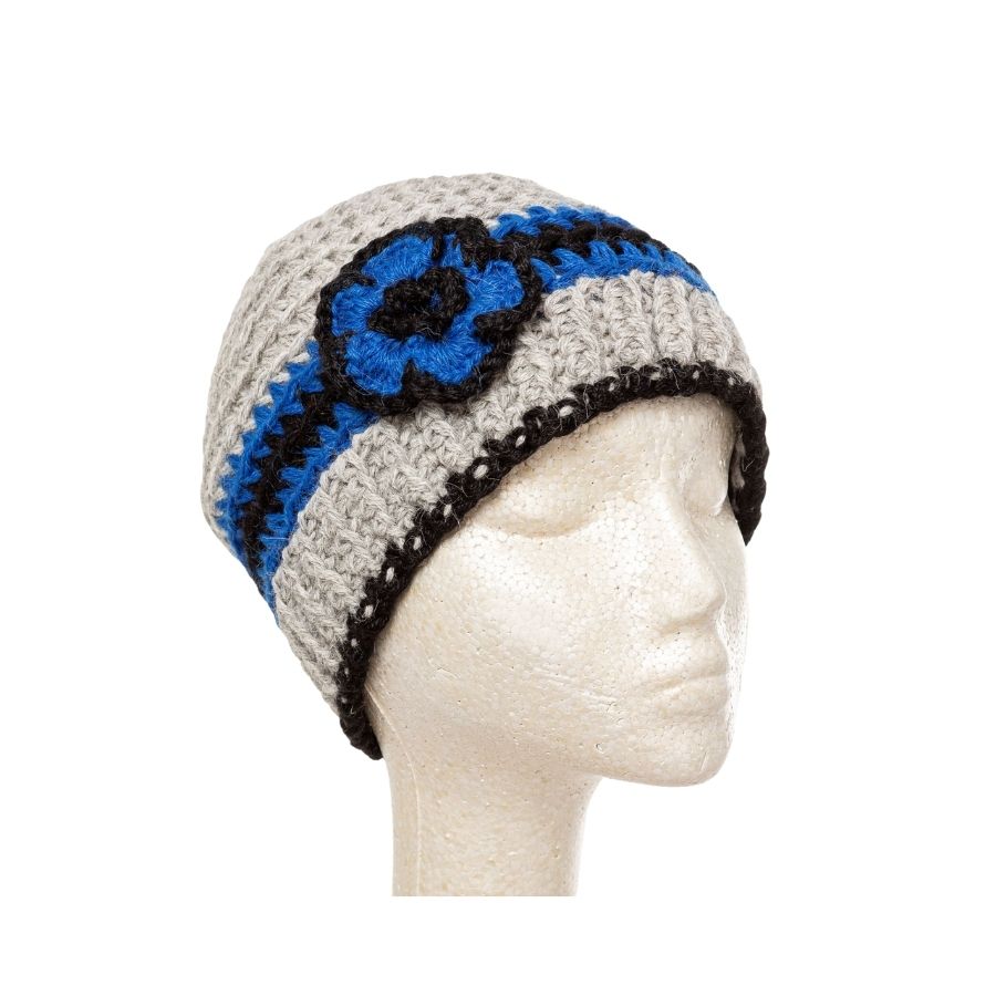 gray blue and black hand knit alpaca beanie hat with flower on mannequin head