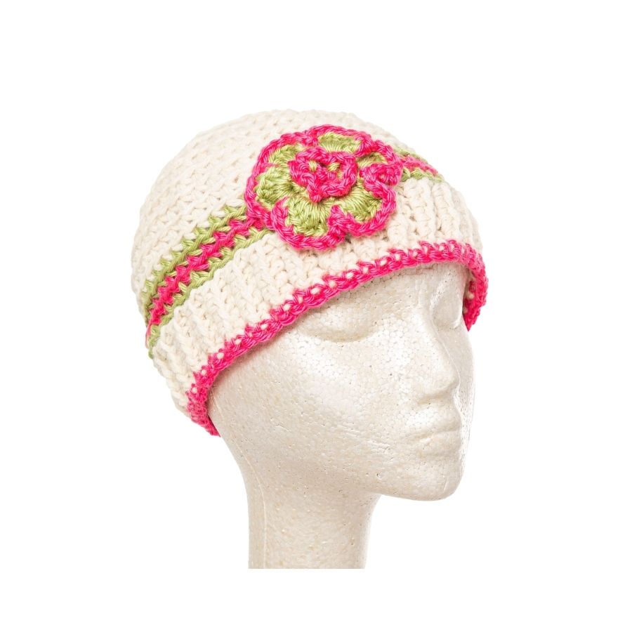 white pink and green hand knit alpaca beanie hat with flower on mannequin head