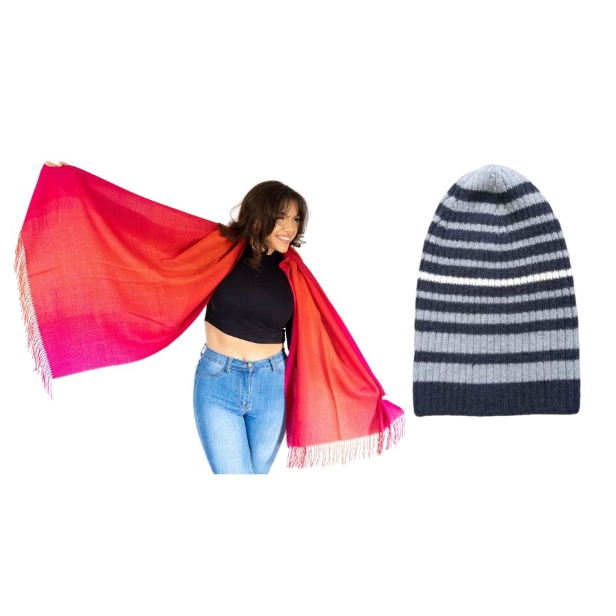woman smiling standing with her arms extended wearing red ruckus colored alpaca wool shawl and product photo of blue striped ribbed alpaca wool beartooth beanie hat
