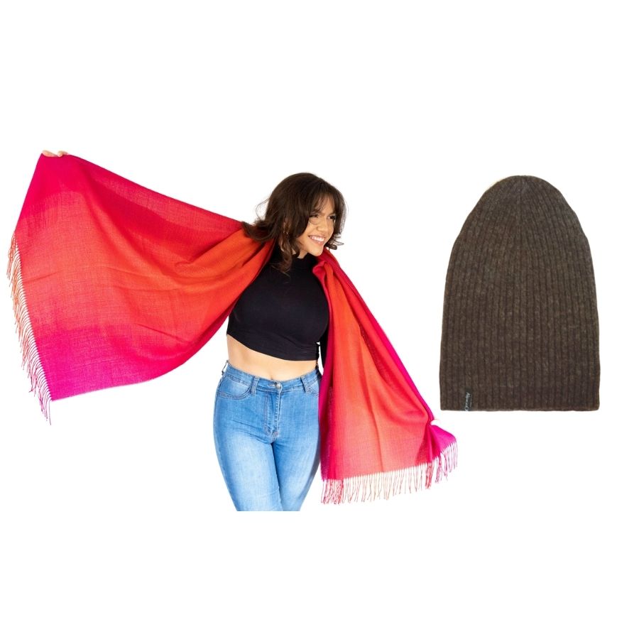 woman smiling standing with her arms extended wearing red ruckus colored alpaca wool shawl and product photo of brown ribbed alpaca wool beartooth beanie hat