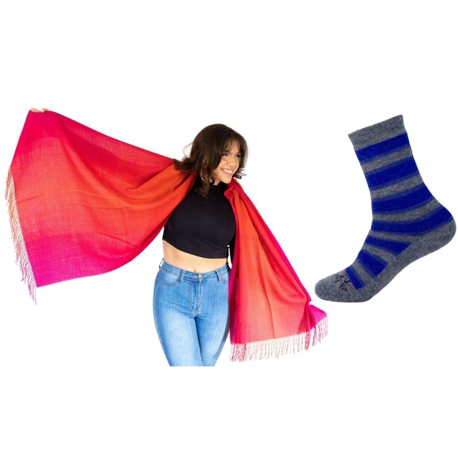 woman with her arms extended holding red ruckus colored alpaca wool shawl and product photo of gray and blue alpaca wool cozy urbanite socks 