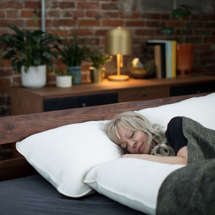 woman sleeping in bed with alpaca wool soft pillows