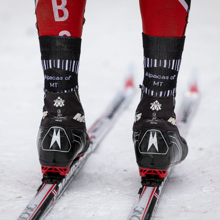 person cross country skiing wearing alpaca wool mid crew socks