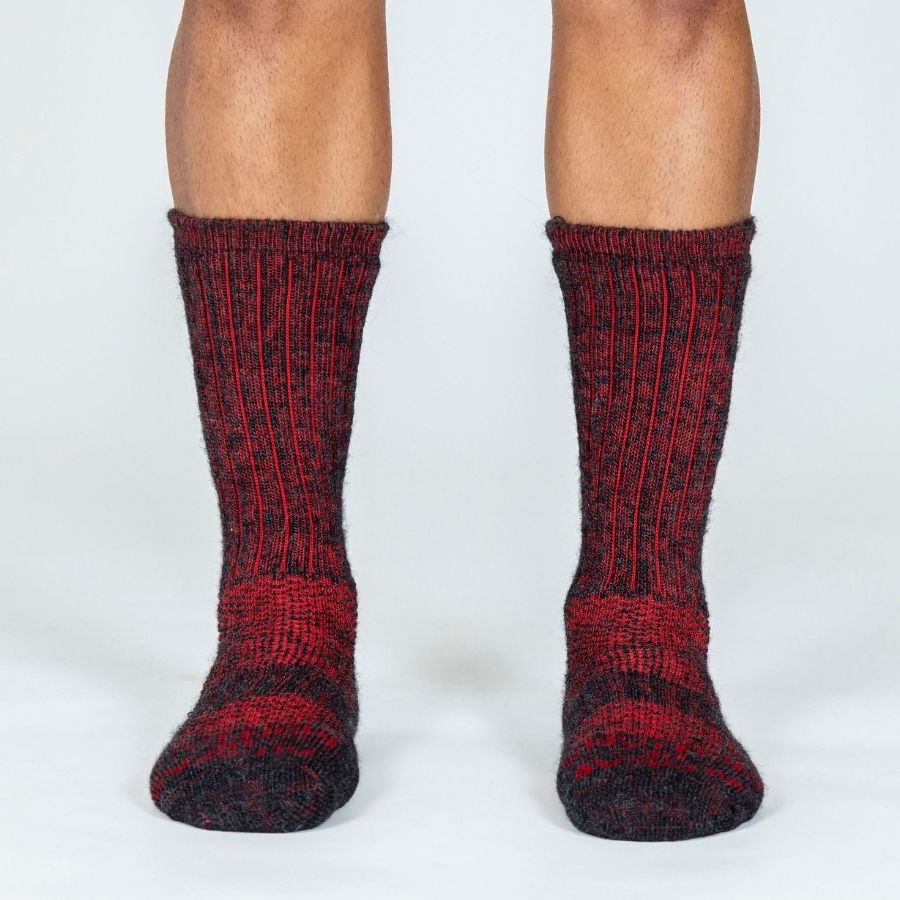 person&#39;s lower legs wearing red alpaca wool extra cushion socks