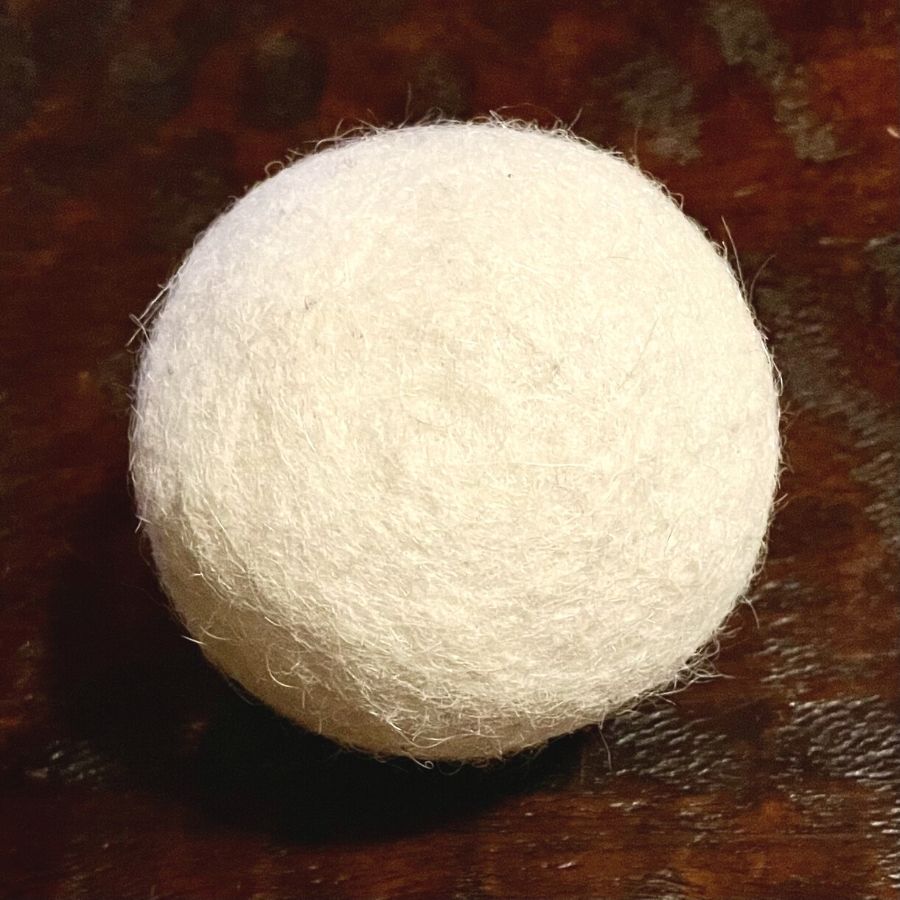 white alpaca wool dryer ball on table