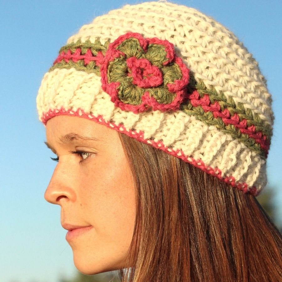 white green and pink hand knit alpaca beanie hat with flower on mannequin head