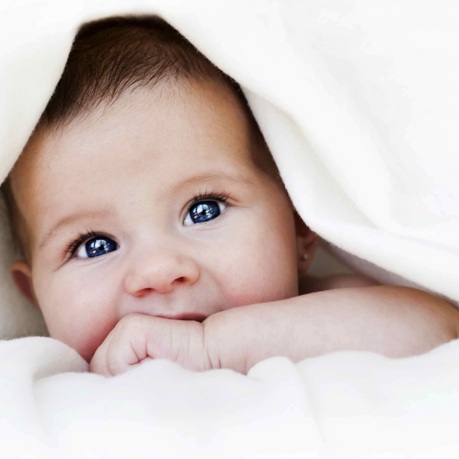  baby curled up in baby blanket